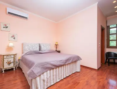 a bedroom with a bed and a chair at Butterfly Garden Villa in Pastida