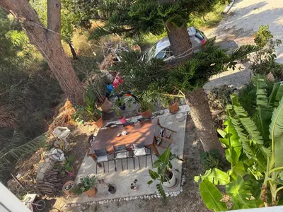 an overhead view of a table and chairs in a garden at Tower Traditional Pool Villa in Kremasti