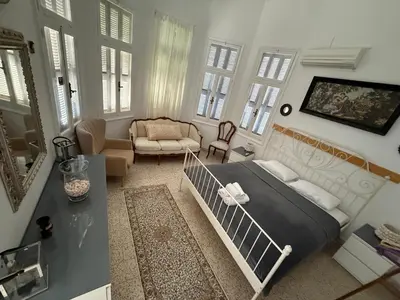 a bedroom with a bed and a living room at Tower Traditional Pool Villa in Kremasti