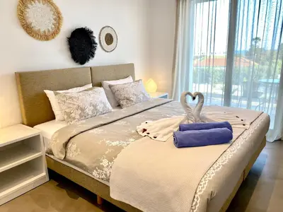 a bedroom with a bed with a large window at Gennadi Harmony Suites - 200 m from the sea in Gennadi