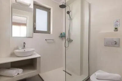 a bathroom with a shower and a sink at Gennadi Harmony Suites - 200 m from the sea in Gennadi