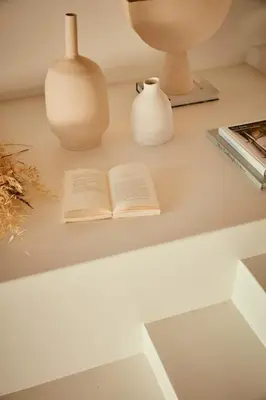 an open book on a table with a lamp and a vase at AF Lindia Nature Design Hotel in Líndos