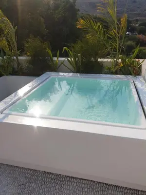 a jacuzzi tub sitting on top of a house at AF Lindia Nature Design Hotel in Líndos