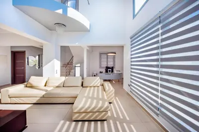 a living room with a couch and a table at Dias Luxury Villa in Koskinou