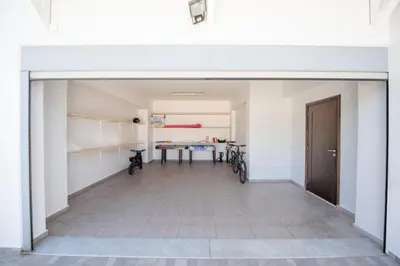 an empty room with a table and two bikes at Dias Luxury Villa in Koskinou