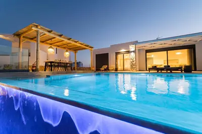 a swimming pool in the middle of a house at Grand Blue Villas Lachania in Lachania