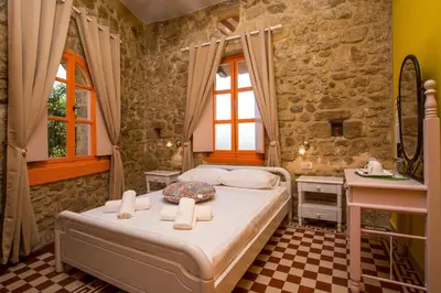 a bedroom with a bed and a sink at Attiki Hotel in Rhodes Town