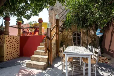 a table and chairs in a courtyard with a building at Attiki Hotel in Rhodes Town