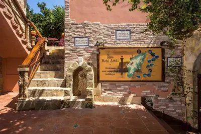 a stone building with a sign on the side of it at Attiki Hotel in Rhodes Town