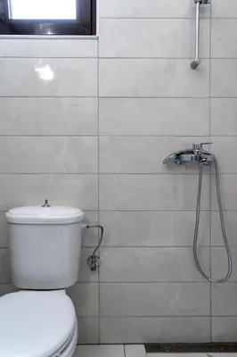 a bathroom with a toilet and a shower at Villa Rafaella2 in Koskinou