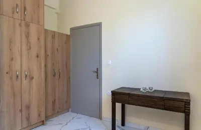 a room with a wooden door and a table at Villa Rafaella2 in Koskinou