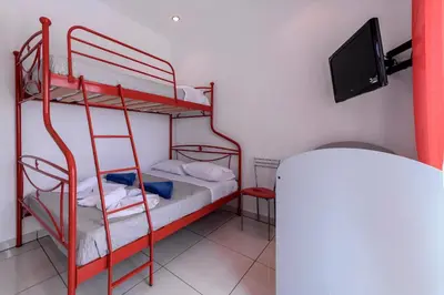 a room with two bunk beds and a flat screen tv at Diamond Villa in Gennadi