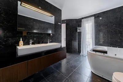 a bathroom with a large white tub and a sink at Diamond Villa in Gennadi