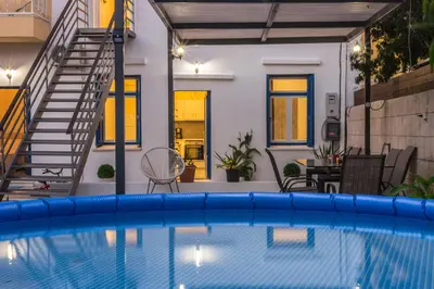 a swimming pool in front of a house at Danai House in Rhodes Town