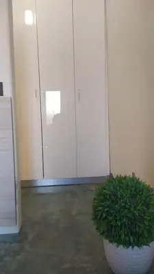 a plant in a white pot in front of a door at Danai House in Rhodes Town
