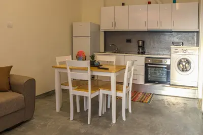 a kitchen with a table and chairs and a stove at Danai House in Rhodes Town