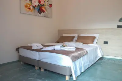 a bed with two towels on it in a room at Danai House in Rhodes Town