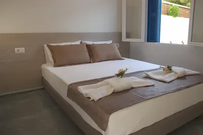 a bedroom with a bed with towels and a window at Danai House in Rhodes Town