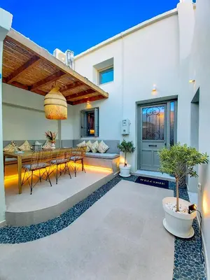 a patio with a table and chairs in a house at Heliareti Traditional House in Koskinou