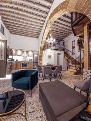 a large living room with a table and chairs at Heliareti Traditional House in Koskinou