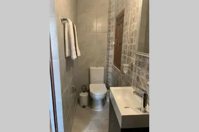 a bathroom with a toilet and a sink at Beautiful historic house in Koskinou