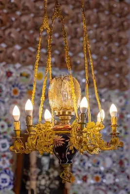 a large gold chandelier hanging from a ceiling at Beautiful historic house in Koskinou