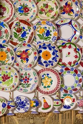 a pile of colorful plates and bowls on a wall at Beautiful historic house in Koskinou