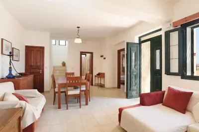 a living room with a couch and a table at Villa Meitani in Kattavía