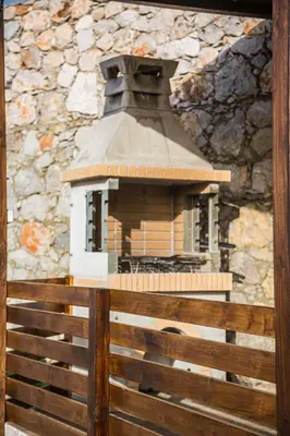 a bird house sitting on top of a wooden fence at Villa Cleopatra Private Heated Pool, Tennis & Football in Koskinou
