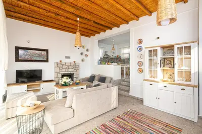 a living room with a couch and a table at CHRYSANTHI'S STONE HOUSE in Afantou
