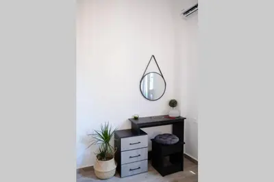 a room with a mirror and a dresser at Potnia House in the center of Rhodes in Rhodes Town
