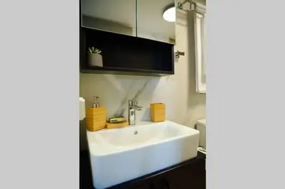 a bathroom with a white sink in a room at Potnia House in the center of Rhodes in Rhodes Town