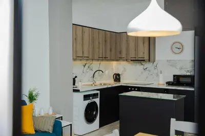 a kitchen with a sink and a washing machine at Potnia House in the center of Rhodes in Rhodes Town