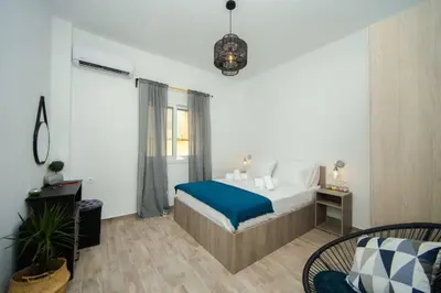 a bedroom with a bed with a blue blanket at Potnia House in the center of Rhodes in Rhodes Town
