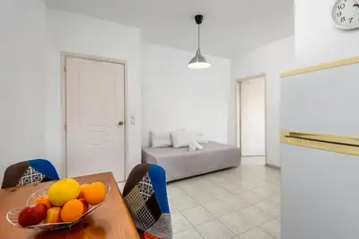 a room with a table with a bowl of fruit on it at ISKAS EVILION in Rhodes Town