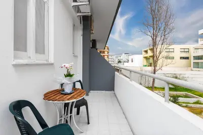 a balcony with a table and chairs and a window at ISKAS EVILION in Rhodes Town