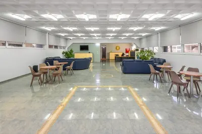 a lobby with tables and chairs in a building at ISKAS EVILION in Rhodes Town