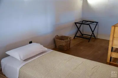 a bedroom with a bed and a side table at 1890 Fanourakis House in Halki