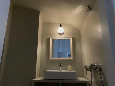 a bathroom with a sink and a mirror at 1890 Fanourakis House in Halki