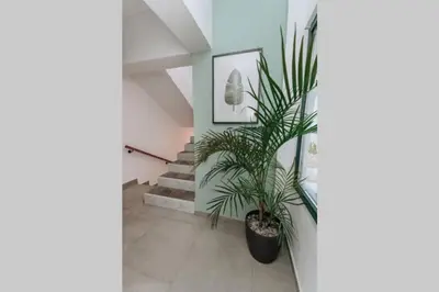 a potted plant in a hallway with stairs at Never Ending Summer Villa in Asgourou