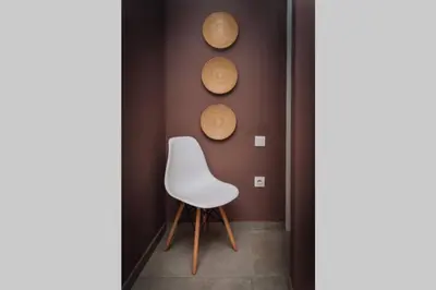 a white chair in a room with a wall at Never Ending Summer Villa in Asgourou