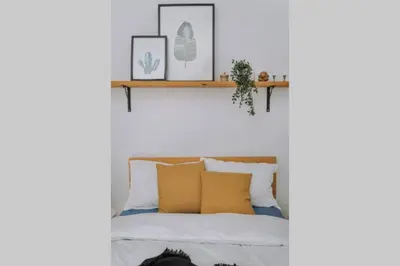 a bedroom with a bed with yellow pillows and a shelf at Never Ending Summer Villa in Asgourou