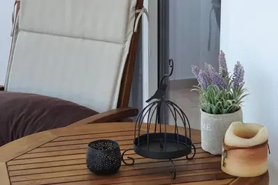 a wooden table with a bird cage on top of it at Amarantou Apartment - Rhodes City Center in Rhodes Town
