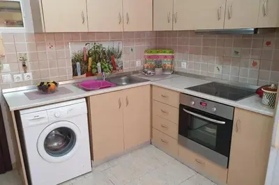 a kitchen with a sink and a washing machine at Amarantou Apartment - Rhodes City Center in Rhodes Town