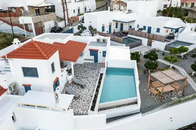 an aerial view of a white house with a swimming pool at Kalathos Square luxury suites in Kalathos