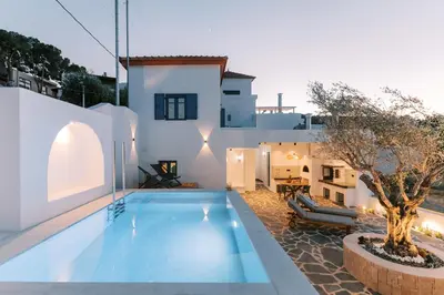 a villa with a swimming pool and a house at Kalathos Square luxury suites in Kalathos