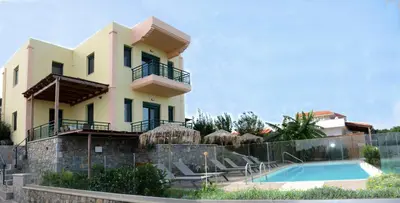 a villa with a swimming pool and a house at Siena Pool Villa in Koskinou