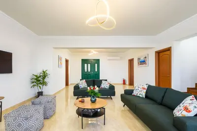 a living room with two couches and a table at Siena Pool Villa in Koskinou