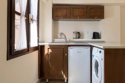 a kitchen with a washer and dryer in it at To Rodi Apartments in Rhodes Town