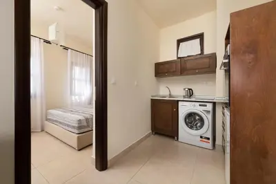 a kitchen with a washer and dryer in a room at To Rodi Apartments in Rhodes Town